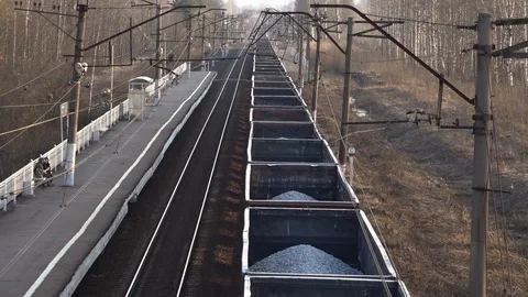 View from above on a freight train traveling past a station into a city. Freight Stock Footage 128079639