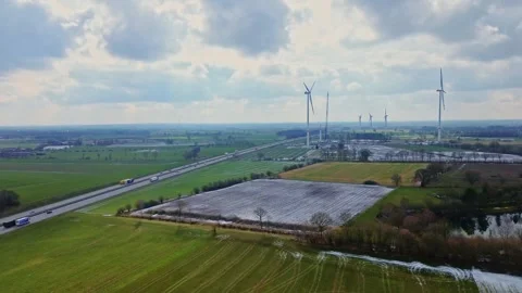 View from above on the German motorway A7 with some windmills for renewable Stock Footage 345761545