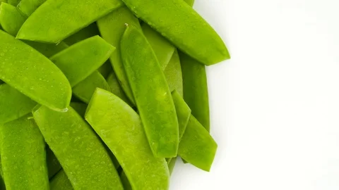 View from above. Half of a circle shaped snow peas pile. Vertically rotating Stock Footage 97391543