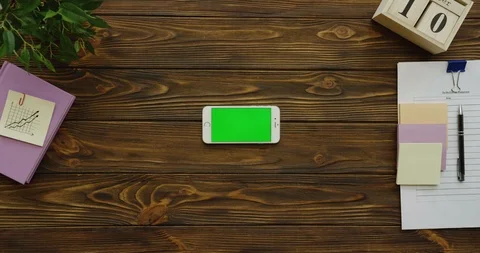 View above on the horizontal white smartphone device with a green screen on the Stock-Footage 88391493