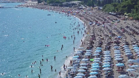 View from above is a large beach on the blue sea beach filled with numerous Stock Footage 201488692