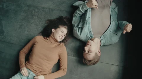 View from above, looking at the camera a young man and woman couple lying on the Stock Footage 130325056