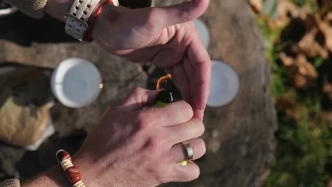 View from above . male hands set fire to an incense stick with a lighter Stock Footage 229858453