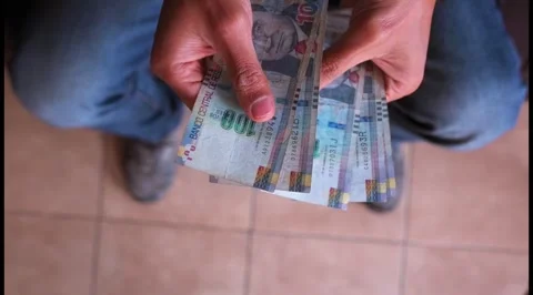 View from above of a man's hands counting 100 soles bills. Stock Footage 283686125