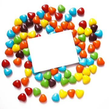 View from above on a multi-colored dragee in the shape of hearts. Postcard for Stock Photos