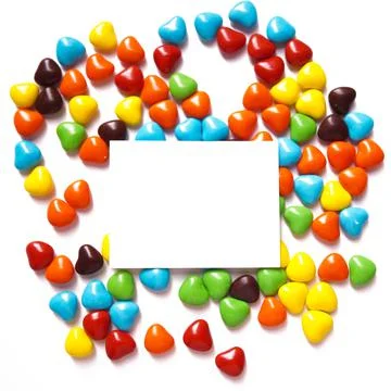 View from above on a multi-colored dragee in the shape of hearts. Postcard for Stock Photos