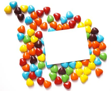 View from above on a multi-colored dragee in the shape of hearts. Postcard for Stock Photos