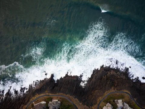 View from above. Ocean with surging waves, storm. Rocky coast. Beautiful seas Stock Photos