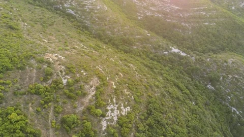 View from above over the mountain and the clear blue sea at sunset Video stock 156484069
