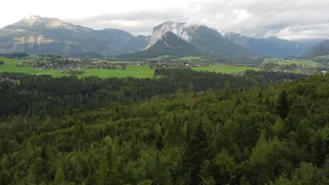 View from above, an overcast day in the alpine mountains, the peaks hidden behin Stock Footage 290078839