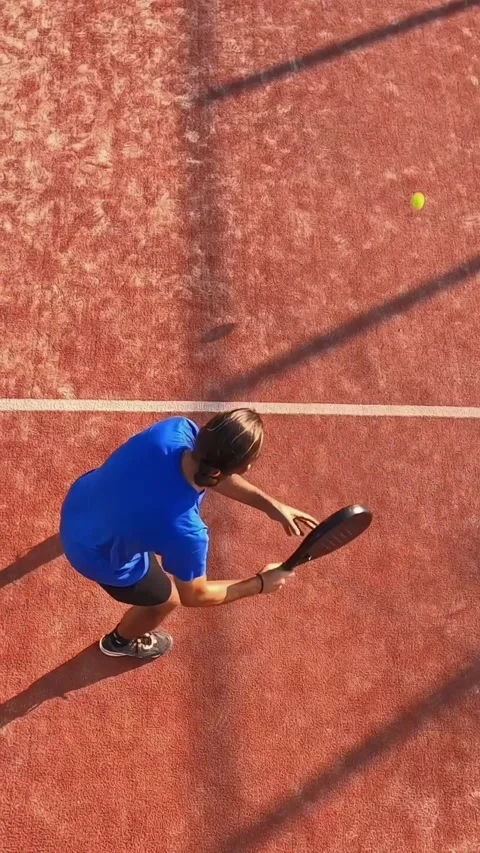 View from above of a padel player quickly hitting the ball and going up to net Stock Footage 313556940