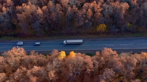 View from above of the paved road that runs through the forest and farm fields Stock Footage 163957616