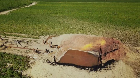 View from above of pit filled with water. Fire. Checking operation of gas Stock Footage 209272539