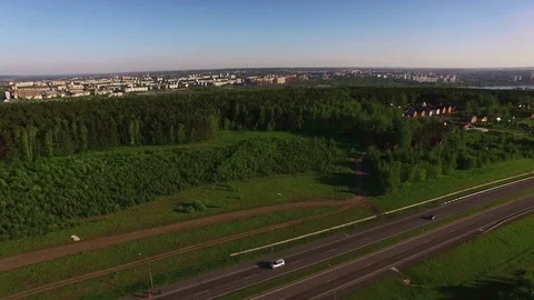 View from above on the road, forest, small river and village Stock Footage 77766415