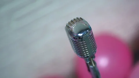 View from above on silver retro glare microphone on scene on blurred background. Stock Footage 119978792