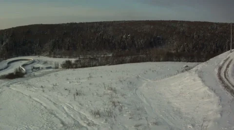 View from above of snow-covered field and forest Видео 45258115