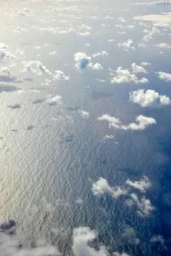 View from above to the surface of the ocean with clouds Stock Photos