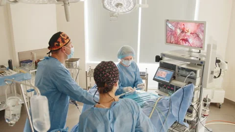 View from above surgeons team preforming operation in hospital operating theater Stock Footage 172754704