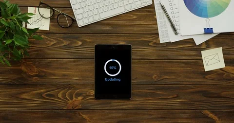 View from above on the tablet device having a program updating on its black Stock-Footage 95098071