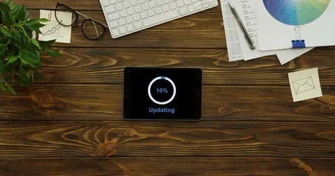View from above on the tablet device having a program updating on its black Stock-Footage 95099766