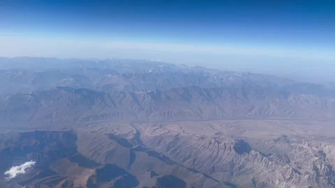 View From Above Through Airplane Window Flying Over Mountains Video stock 292096519