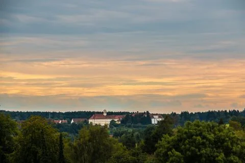 View above the trees of the green forest toward the cloister Stock Photos