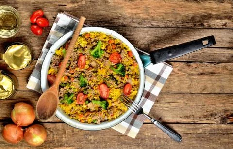 View from above of tuna risotto with vegetables, tomatoes, broccoli and parsley Stock Photos