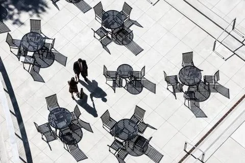 View from above of two business people meeting outside in an open air cafe area. Stock Photos