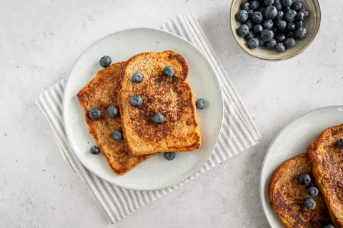 View from above of two plates with french toast with blueberries Stock Photos