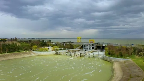 View from above of the water rushing through the gates of the dam at the Stock Footage 185050057
