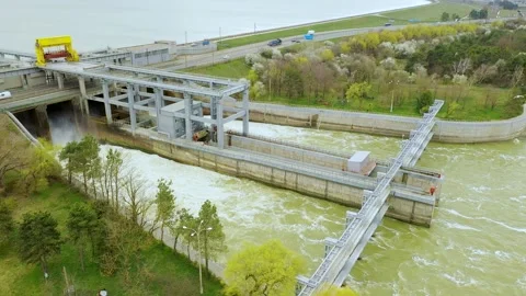 View from above of the water rushing through the gates of the dam at the Stock Footage 185058741