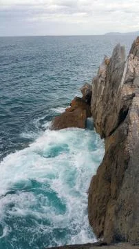 View from above of waves bumping against rocks. Cold morning on Cantabria sea Stock Photos