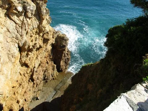 View from above of the waves on the rocks c Stock Photos