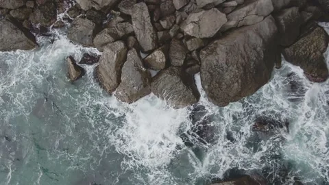 View from above on the waves of the surf in the coastal rocks Stock Footage 132167988