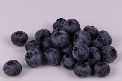 View from above on white background with black blueberries with shades 库存照片