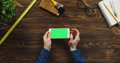View from above on the white horizontal smartphone on the wooden desk with Stock-Footage 96176099