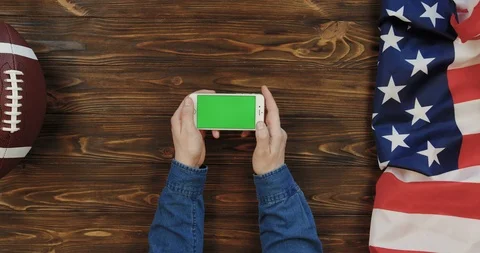 View from above on the white horizontal smartphone on the wooden table with Video stock 96316718