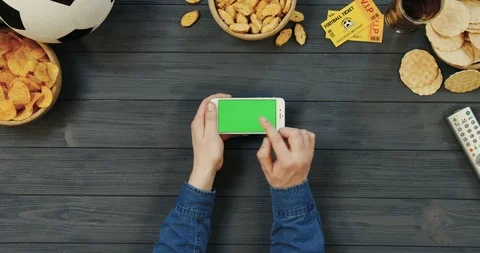 View from above on the white horizontal smartphone on the dark grey wooden table Stock Footage 96437492