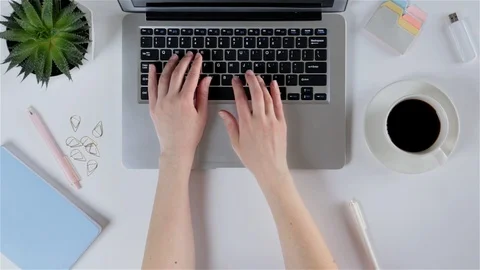 View from above of white office desk table with laptop, notebook, cell phone Stock Footage 93341853
