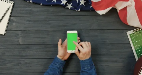 View from above on the white smartphone device lying vertically on the dark grey Video stock 96339183