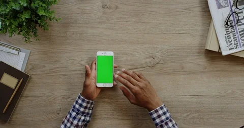 View from above on the white smartphone lying vertically on the wooden light Stock-Footage 96012913