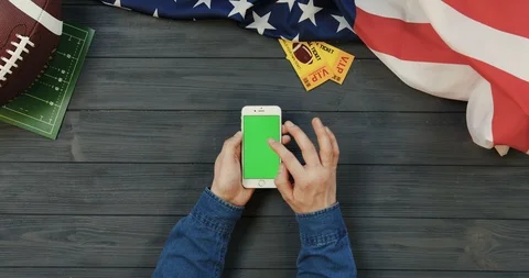 View from above on the white smartphone lying vertically on the dark grey wooden Stock Footage 96342535