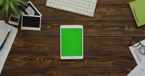 View from above on the white tablet computer with a green screen lying Stock Footage 88416709