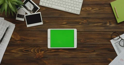 View from above on the white tablet computer with a green screen lying Video stock 88417056