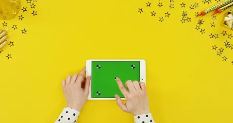 View from above on the white tablet device on the yellow table with birthday Stock-Footage 89324717