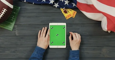 View from above on the white tablet device lying vertically on the dark grey Stock Footage 96339482