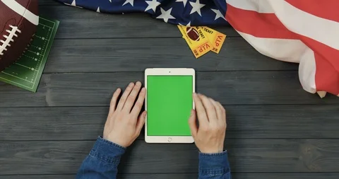 View from above on the white tablet device lying vertically on the dark grey Video stock 96339990