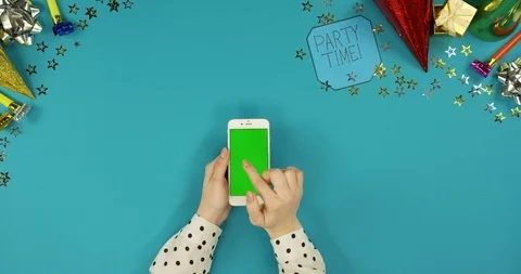View from above on the white vertical smartphone lying on the blue table with Stock Footage 89315714