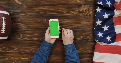 View from above on the white vertical smartphone on the wooden table with rugby Video stock 96316815