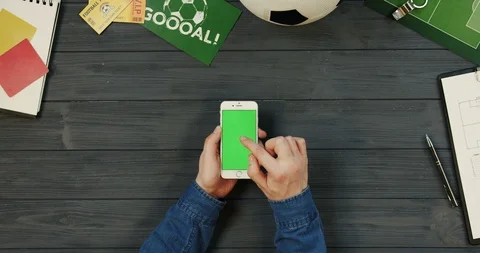 View from above on the white vertical smartphone on the dark grey wooden desk of Stock Footage 96335749